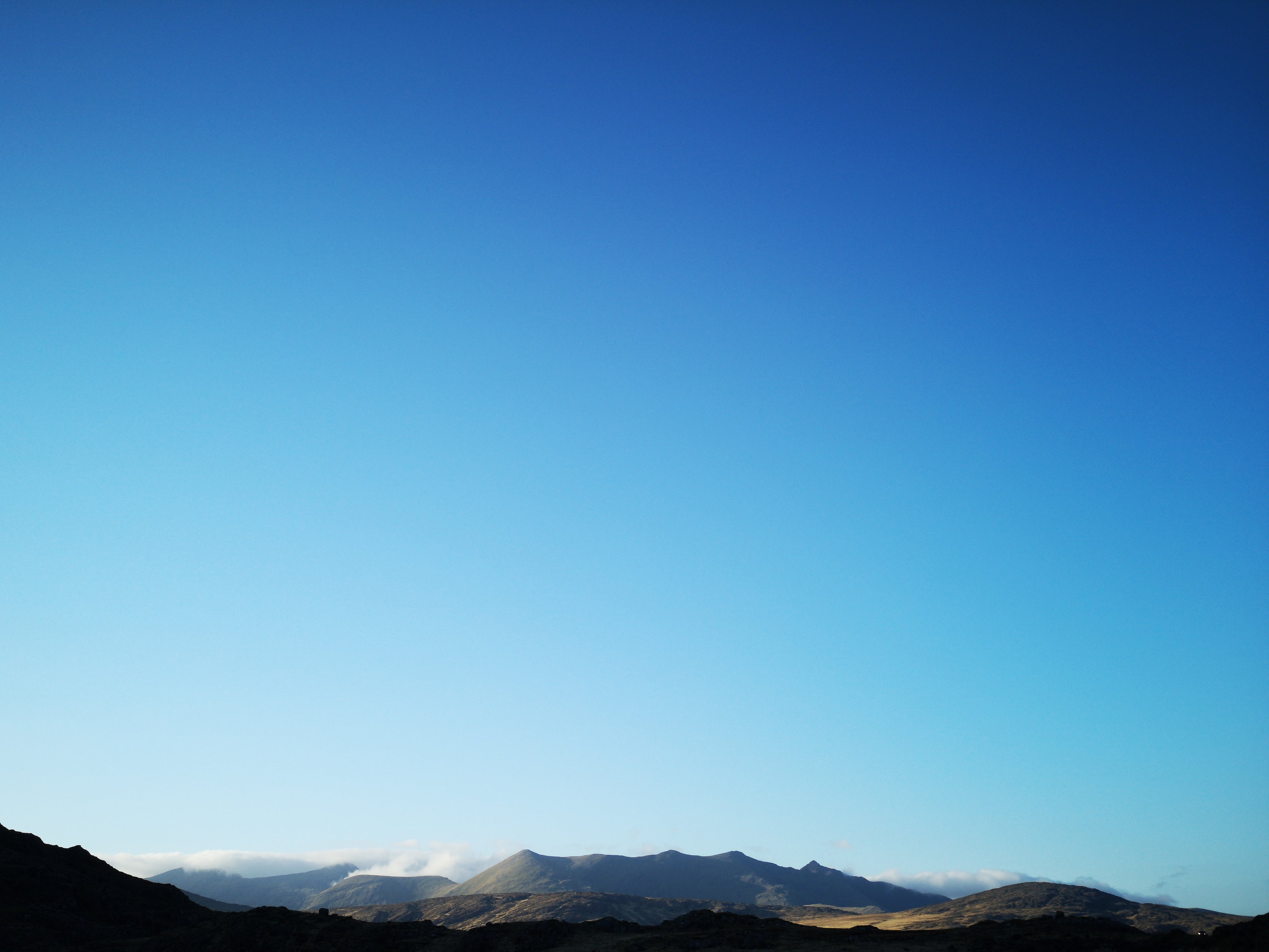 the-blue-sky-over-sunlit-mountains.jpg
